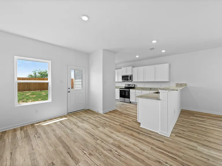 Dining room with a window and door to the backyard.