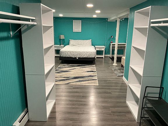 Closet area with shelving for shoes, clothing