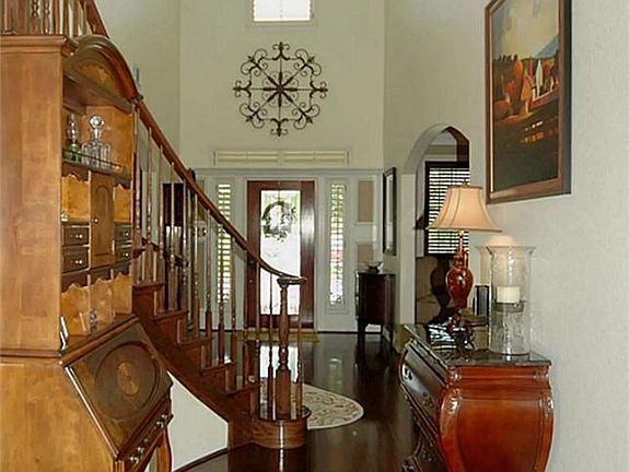 The leaded glass door opens to a wonderful 2 story foyer that is sure to make a fantastic first impression. All wood downstairs is real, stairs / game room & 1 bedroom up have laminate wood floors.