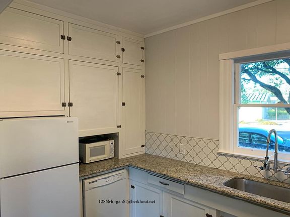 Other end of kitchen, with fridge & dishwasher. Large basin sink.