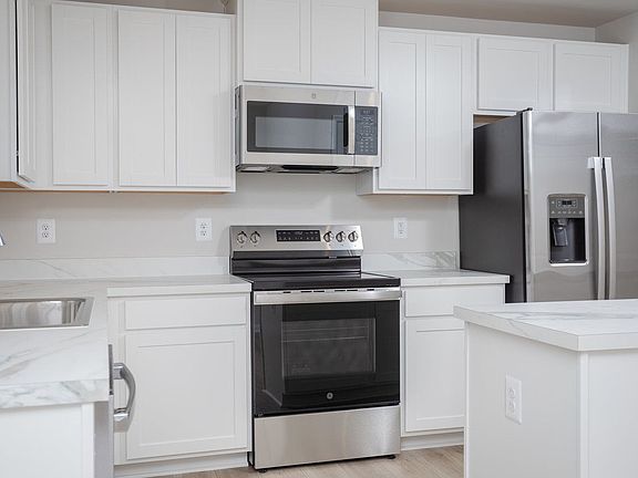 Here you have lots of counter and cabinet space, stainless steel appliances, a versatile island and window overlooking the backyard to bring in natural light.