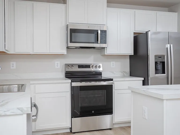 Here you have lots of counter and cabinet space, stainless steel appliances, a versatile island and window overlooking the backyard to bring in natural light.