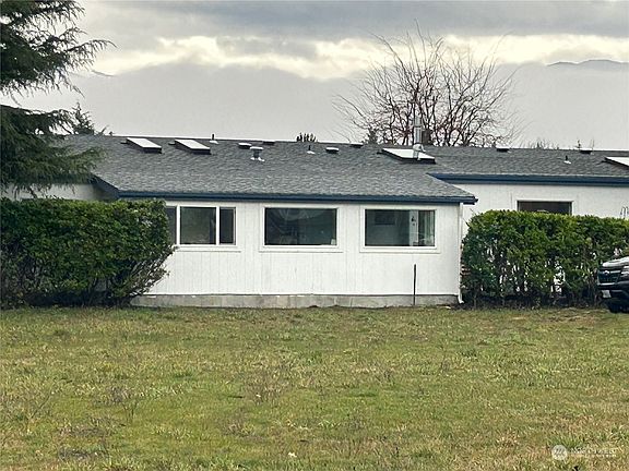 Back of home showing sunroom >