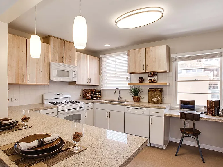 Kitchens have quartz countertops, gas stoves and breakfast bars in select homes