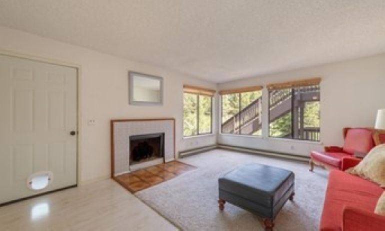 Convenient ground floor entry. Semi-furnished living room with gas fireplace and creek views.