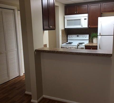 Dining area looking over bar into kitchen.