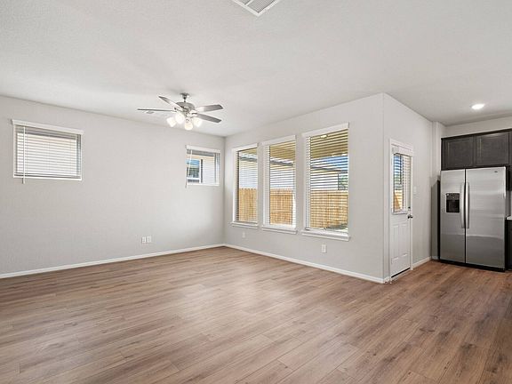 A view of the living room with large windows allowing plenty of natural light in.