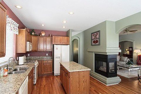 Kitchen with island and shared fireplace