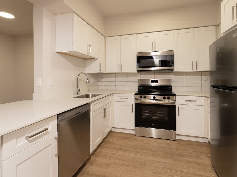 Kitchen with island and hard surface flooring