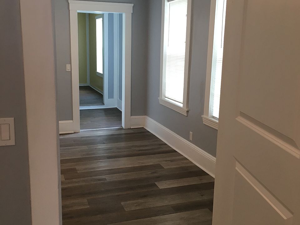 Looking from the bedroom through to living room and kitchen