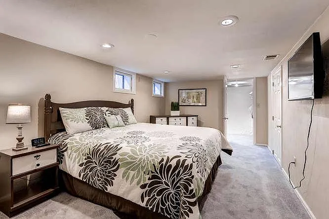 Relaxing 3rd bedroom with king bed, walk-in closet, and flat