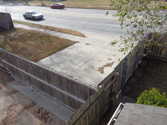 Street entrance with cedar privacy sliding gate