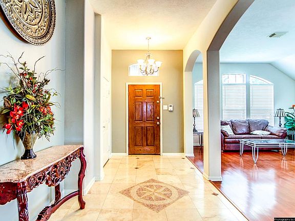 Grand foyer and entry way with travertine tiles  and tiles through out the house