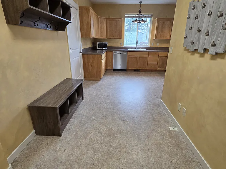 View of mudroom and kitchen from laundry room + half bath