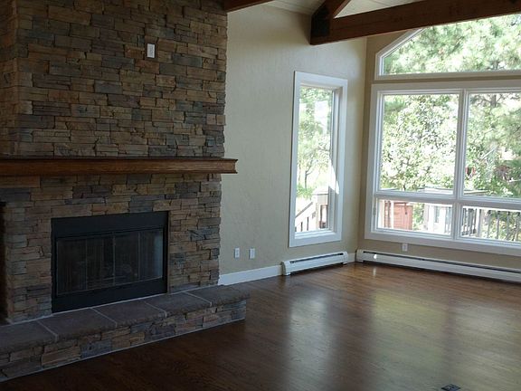 Stone Fireplace in Window covered Living Room