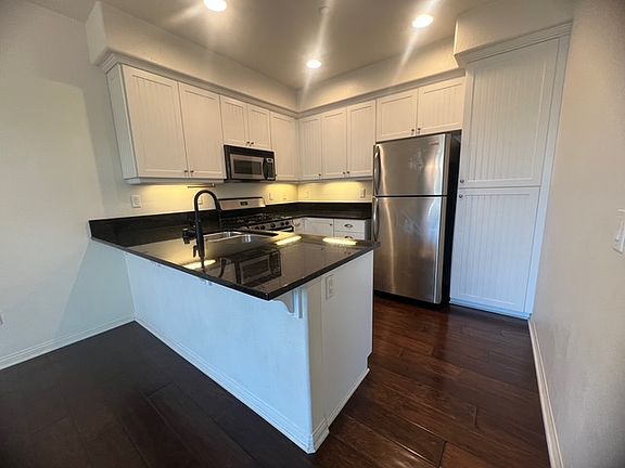 Stainless steel kitchen appliances and granite countertop
