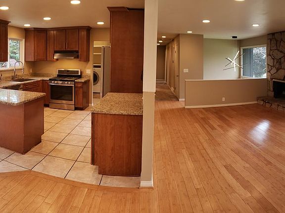 Tiled kitchen and bamboo floored living room facing west