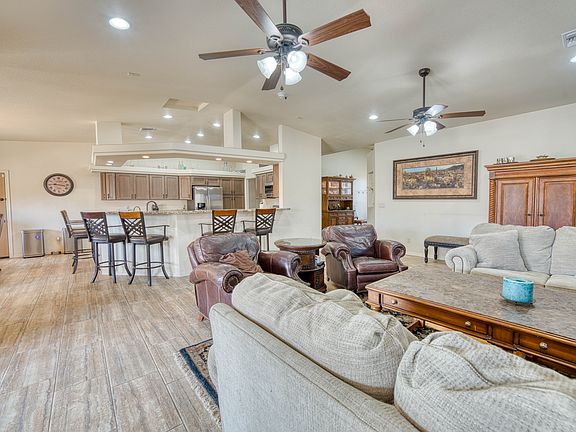 Open-concept living and dining area_perfect for cooking, dining, and entertaining together. Features two ceiling fans, AC, heating, and a TV