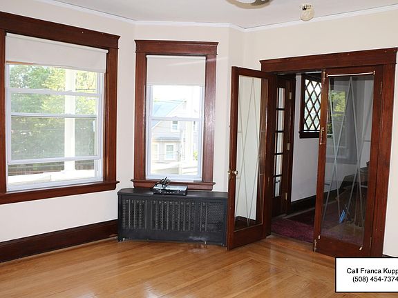 Living room / French doors to carved entrance, stairway and 