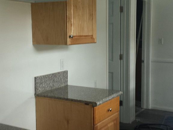 opposite side of galley kitchen showing access to living roo