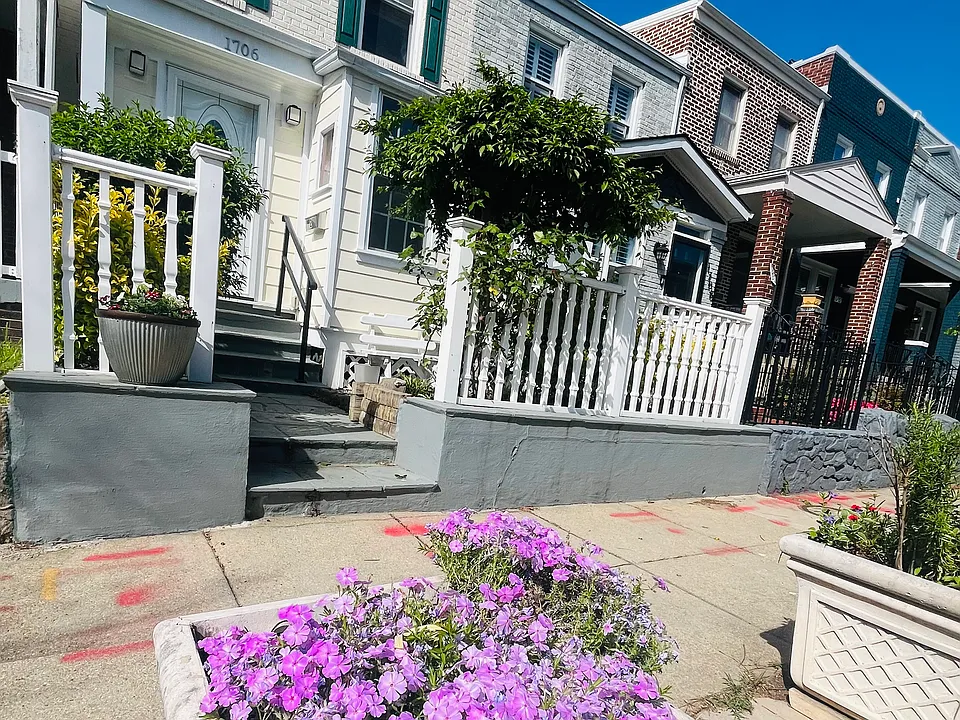 Front of the house, including an outdoor chair next to the window