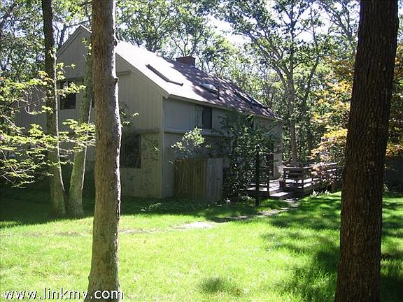 Lovely yard, large deck and outdoor shower offer easy summer living.
