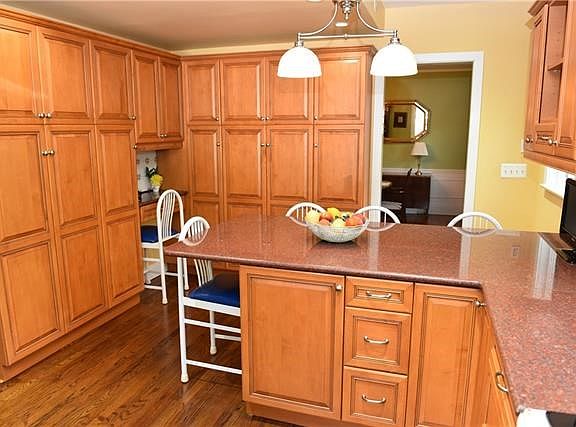 This kitchen view accentuates the plentiful custom cabinetry for all your storage needs, plus the built-in desk. The breakfast b