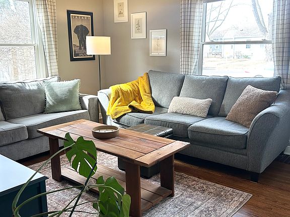 Cozy living room with two couches, ottoman and a coffee table.