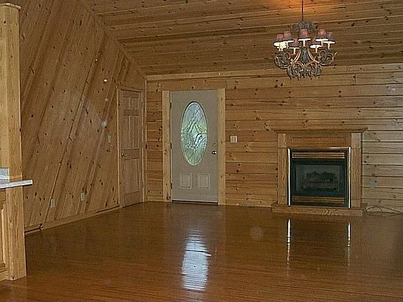Gleaming wood floors, ceilings and walls in LR, dining area, Kit. & hallway