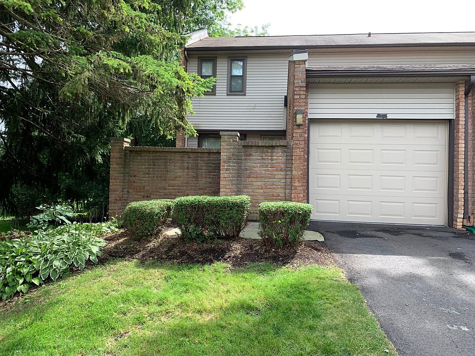 Front of condo with 1 car attached garage