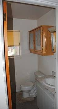between the kitchen and family room is the half bath and laundry area