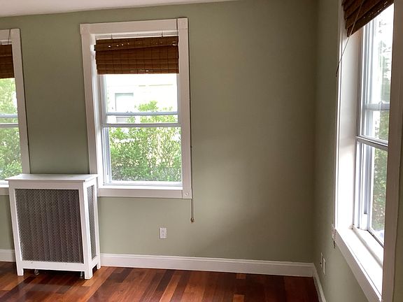 The living room measures 13'6" by 12'10" and has tall ceilings and large windows.