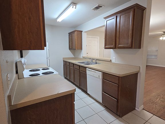 Kitchen with full size refrigrator, microwave and dishwasher.