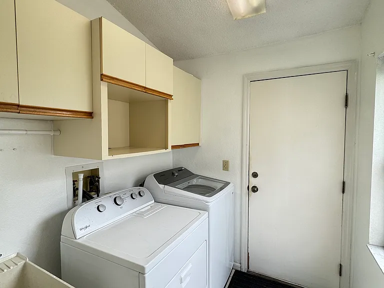 Laundry room with washer & dryer, the door opens to the garage