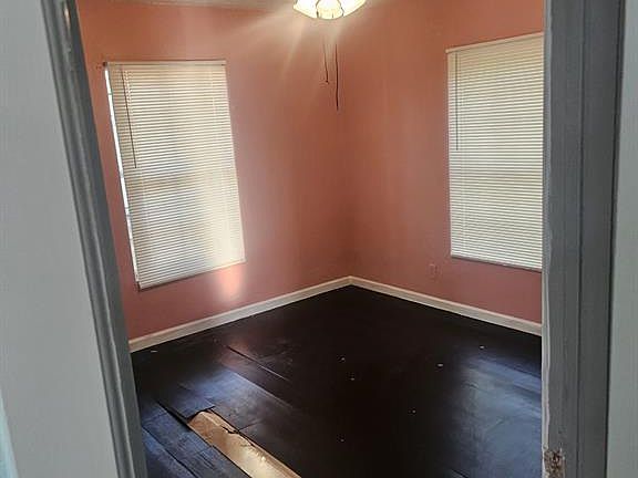 Spare room with ceiling fan, dark hardwood / wood-style floors, and a textured ceiling