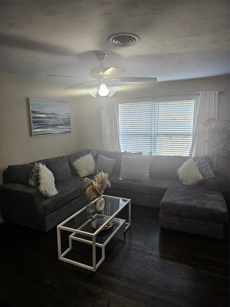 Living area featuring dark wood-style flooring and a ceiling fan - 9911 Ferguson Rd