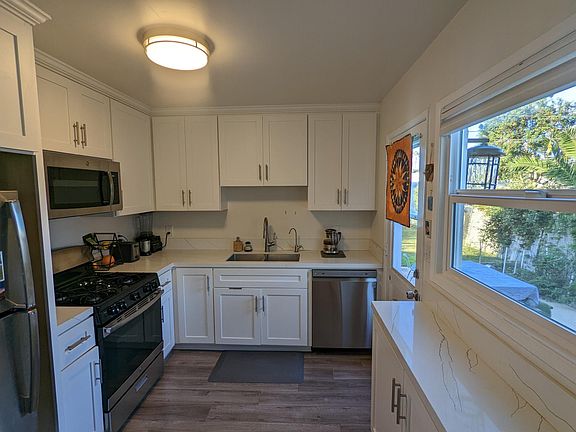 Kitchen opens onto back patio and backyard