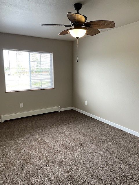 Bedroom 2 with ceiling fan and walk in closet