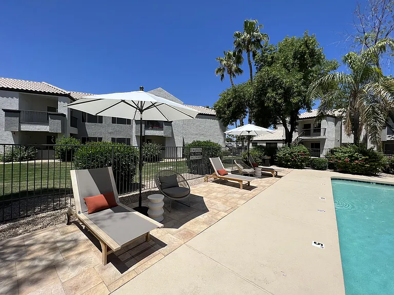 Dive into relaxation in our backyard paradise. Enjoy poolside comfort with chic chairs and shady umbrellas