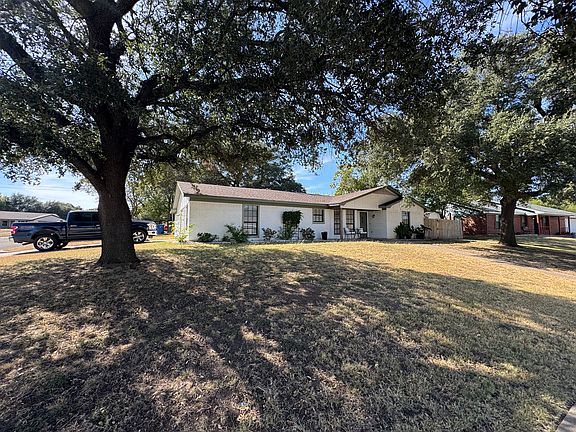 Left, Front of Home with Large Oaks and Updated Landscaping