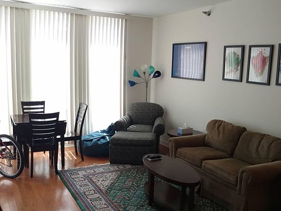 Sunny, large living room area with hardwood floor (picture t