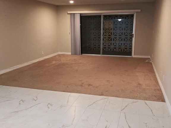 Living/dining room looking from the entryway towards the enclosed patio