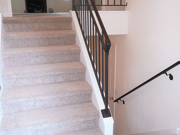 Main entry has newly installed ceramic tiling, even the rod-iron rails were just recently installed.