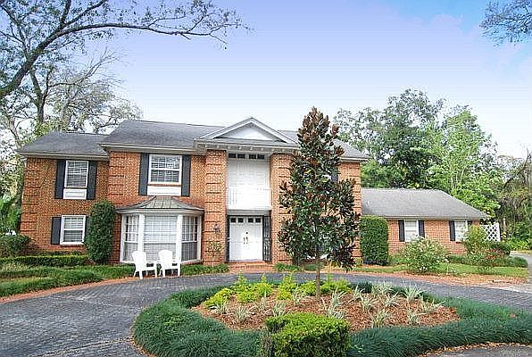Front of Home with circular brick drive