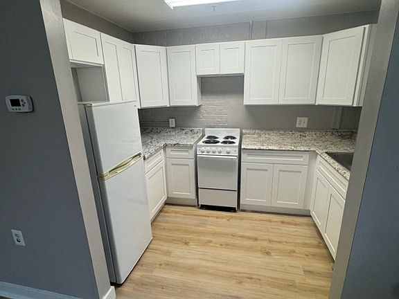 Representative Unit 104 kitchen, from the July 2025 property photo report. Features and layouts vary by apartment.