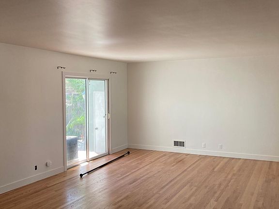 Looking from the other side of the living room at the sliding door that goes out to the courtyard, in the back.