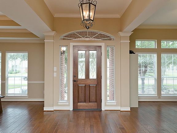 Hand scraped wood flooring, glass lead mahogany front door, updated harvest bronze hardware complete this fantastic entrance.