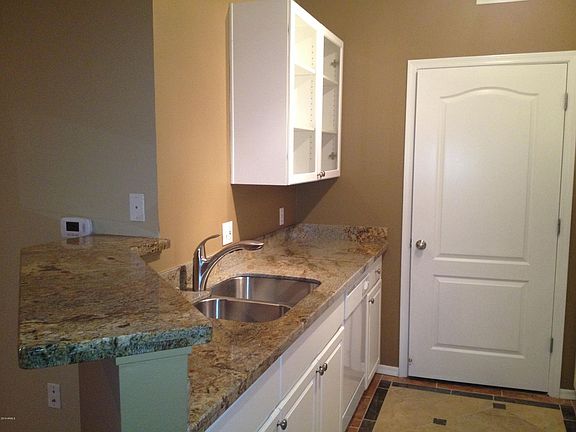 Granite counter tops with contemporary white cabinetry.