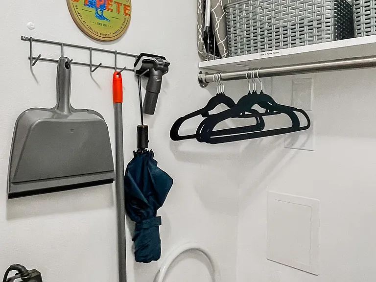 Vacuum, broom, umbrella, folding ironing board and iron etc.