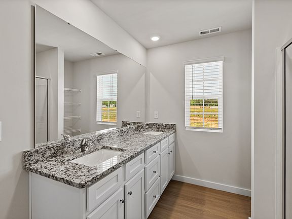The master bathroom includes a stunning dual-sink vanity